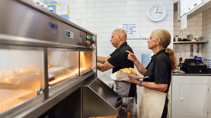 Two employees working at a deli