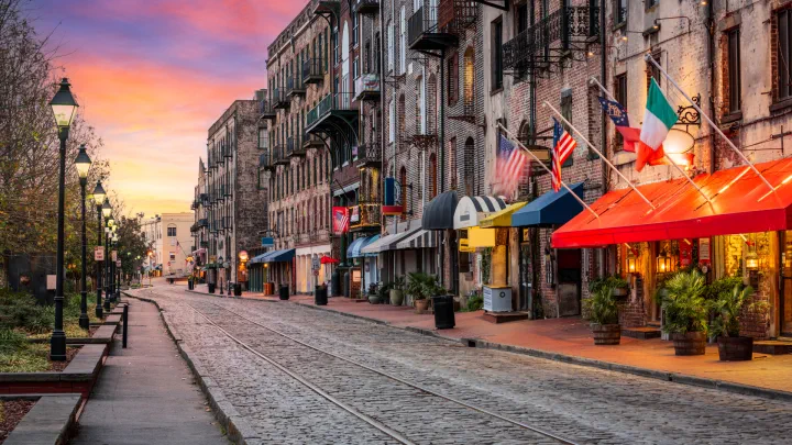 A city street with apartments and shops