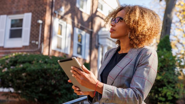 Female business owner holding an ipad looking at a property