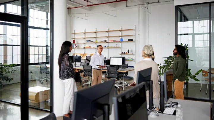 Employees gathered around at their place of business